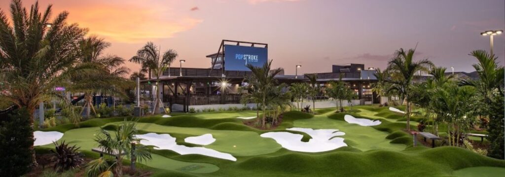 Front of the Pop strokes in Fort Myers's building, in the center is where cornhole is played