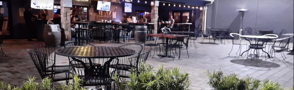 Outdoor area at Rusty's Raw Bar and Grill in Fort Myers Florida where cornhole is played