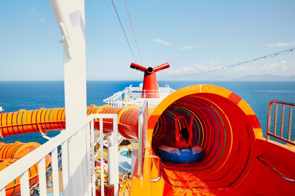 A Kid going down a waterslide on a Carnival Cruise