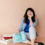 Marcella Kuchar of Best Adventure Spots holding a travel magazine