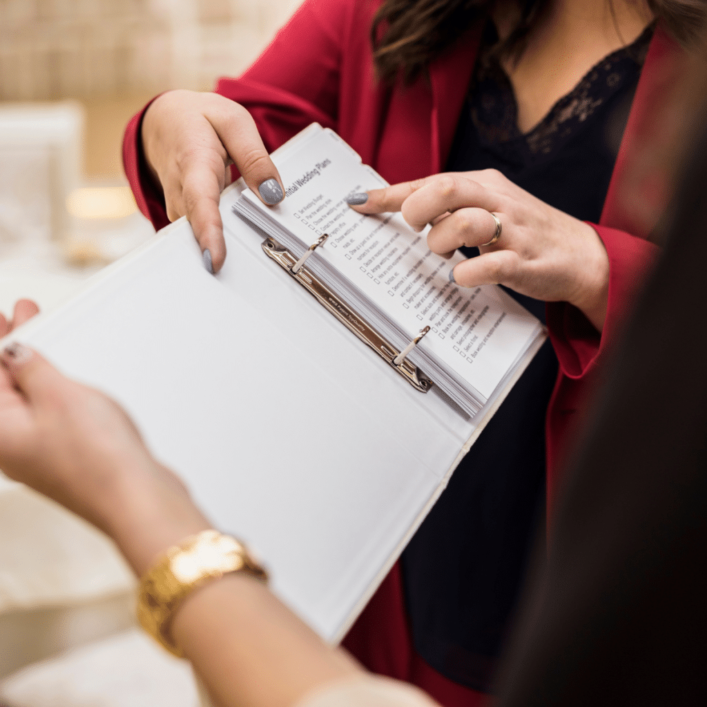 Event planner pointing to details in a book