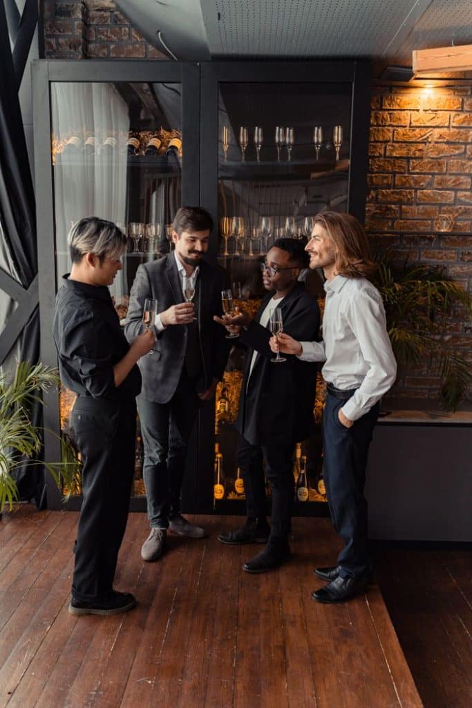 pexels-photo-6759184-6759184 A diverse group of adults enjoying a toast in formal business attire, indoors.